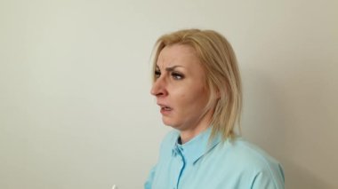 Pretty woman sneezing into a tissue. Cold, allergy, medicine and healthcare concepts