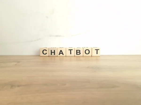 Stock image Word chatbot made from wooden blocks. Customer support service, artificial intelligence concepts