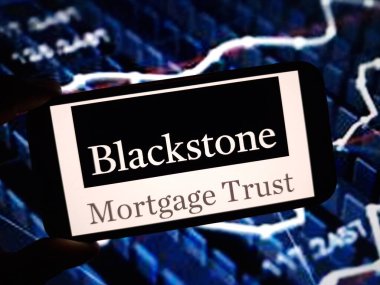 Konskie, Poland - May 11, 2024: Blackstone Mortgage Trust company logo displayed on mobile phone clipart