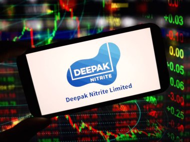 Konskie, Poland - May 27, 2024: Deepak Nitrite company logo displayed on mobile phone clipart