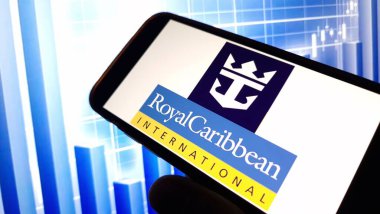 Konskie, Poland - November 18, 2024: Royal Caribbean company logo displayed on mobile phone clipart