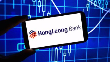 Konskie, Poland - December 24, 2024: Hong Leong Bank company logo displayed on mobile phone clipart