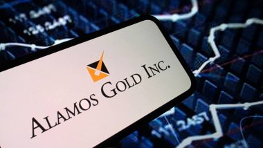 Konskie, Poland - February 15, 2025: Alamos Gold Inc company logo displayed on mobile phone clipart