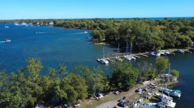 Aerial drone footage of Toronto Island marina with a clear view of the Toronto city skyline. Showcasing boats, waterfront, and the urban landscape. Color graded cinematic look.
