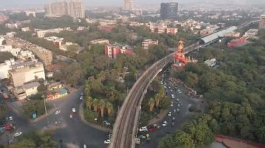4k Drone Hyperlapse of Delhi Metro train at Hanuman Temple Karol Bagh Metro Station in New Delhi India  Delhi roads  Delhi traffic cars Aerial timelapse 