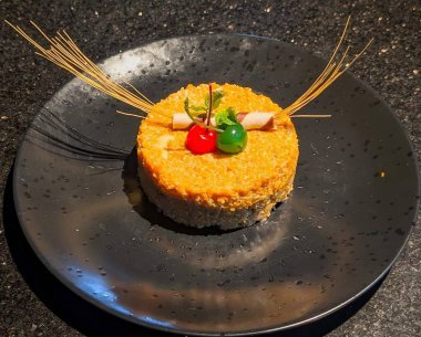 Elegant dessert cake served on a black plate, topped with red and green cherries, mint, and wafer sticks. Perfect for celebrations, parties, and bakery concepts.