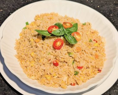 Shrimp fried rice served in a white bowl with fresh herbs. Great for seafood, Asian cuisine, and gourmet food concepts.