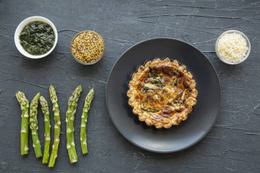 Traditional vegetable tart quiche with asparagus and cheese, top view. 