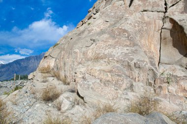 Prehistoric Petroglyphs in Hunza valley, sacred rock of Hunza, rock carvings in Gilgit Baltistan, Pakistan.  clipart