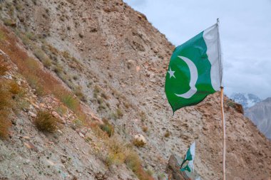 Trekking to Hopper Glacier in Pakistan. Pakistan national flag.  clipart
