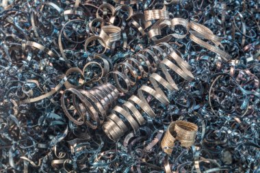 Torna tezgahında çalıştıktan sonra metal spiral talaşı. Görüş açısı. Tasarım için arkaplan.