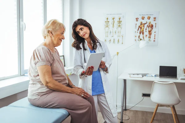 stock image female doctor with her senior patient looking at tablet pc