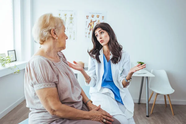 stock image doctor giving senior woman at nursing reception