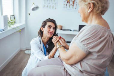 Yaşlılarla ilgilenmenin işareti. Yardım eli uzatıyorum. Yaşlılara özen gösterin. Mutlu ve yaşlı bir kadınla ilgilenen kadın bir doktor. Sağlık ziyaretçisi ve yaşlı bir kadın. 