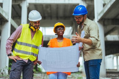 İnşaat alanında planı olan bir grup mimar
