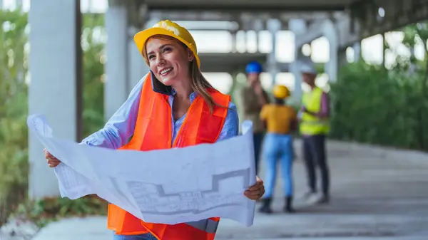 Caucasian Female Worker Using Smartphone Holding Blueprint Construction Site — Stock Photo, Image