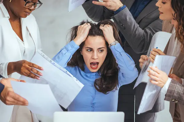 Stressed overwhelmed businesswoman feels tired at corporate meeting, exhausted  female boss suffering from headache touching temples at team briefing, stress at work or migraine concept