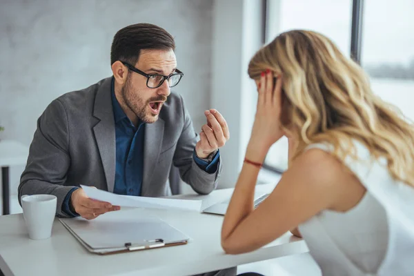 Angry businessman arguing with businesswoman about paperwork failure at workplace, executives having conflict over responsibility for bad work results, partners disputing about contract during meeting