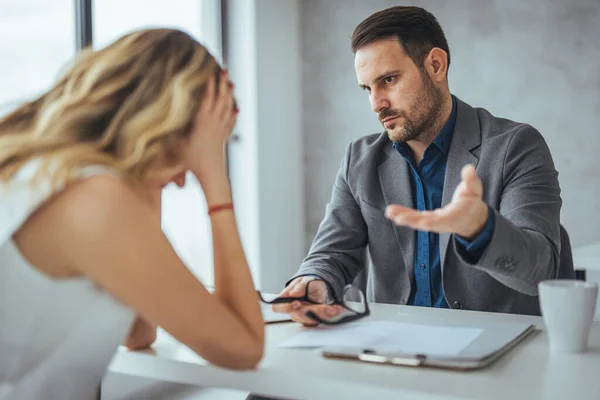 Angry businessman arguing with businesswoman about paperwork failure at workplace, executives having conflict over responsibility for bad work results, partners disputing about contract during meeting