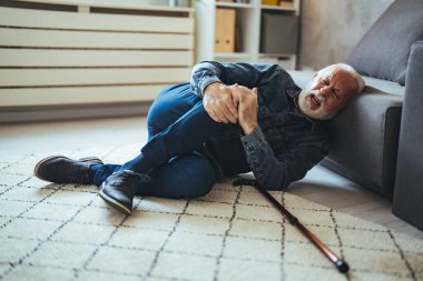 Senior man falling on the ground with walker in living room at home. Elderly older mature male having an accident heart attack for emergency help support from hospital. Insurance health care. clipart