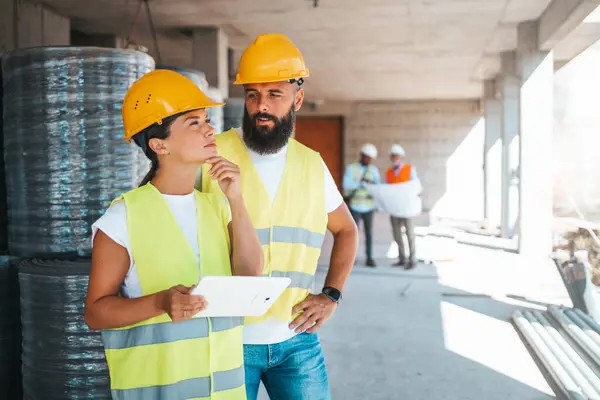 Young Caucasian Architects Engineers Working Digital Tablet Construction Site Blurred — Stock Photo, Image