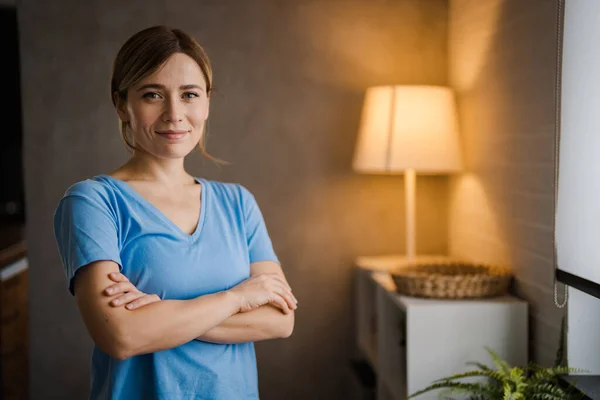 Young beautiful woman at home happy face smiling with crossed arms looking at the camera. Positive person. Portrait of smiling middle-aged woman. Happy friendly casual teen girl looking at camera, smiling cheerful woman