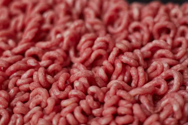 Fresh beef minced meat texture background. Top view of raw beef forcemeat.