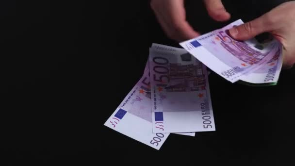ハンドは 異なるヨーロッパの貨幣紙幣を他方の紙幣の上に数えています 500ユーロ紙幣のカウント ブラックバック — ストック動画