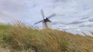 Consuegra Köyü 'nün tepesindeki eski yel değirmeni. Rüzgarda savrulan otlar. Devlerin ve Don Kişot hikayelerinin diyarı..