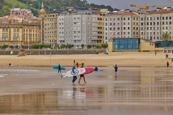 stock image People surfing on Zurriola beach in Spanish town San Sebastian. San Sebastian, Spain - September 9, 2024.