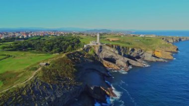 İspanya 'nın Santander kentindeki kayalık sahildeki Cape Mayor deniz fenerinin (Faro de Cabo Mayor) havadan görüntüsü. Zaman turları.