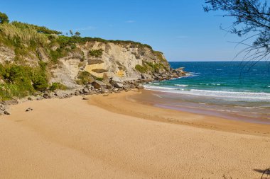 Sunny day on a Matalenas Beach in Santader, Spain. clipart