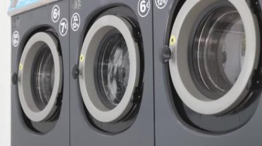 Renkli giysiler çamaşırhanedeki çamaşır makinesinde yıkanır.
