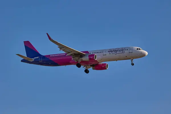 Havayolu Wizzair tarafından işletilen ticari bir jet Airbus A321 iniş takımlarını genişleterek iniş yapmaya hazırlanıyor. Valencia, İspanya - 11 Mayıs 2025.
