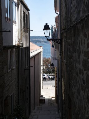 08.23.2024 Rua da Lua, Muros Galicia, Spain: Typical narrow street in the Galician village Muros in Spain clipart