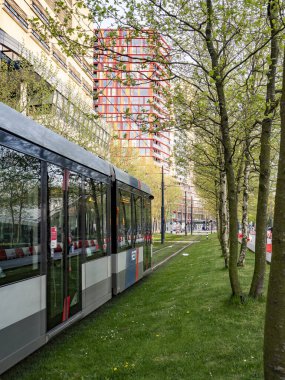 Modern tram in Rotterdam running on electric power, highlighting eco-friendly city mobility.