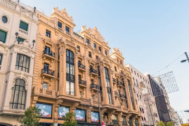 Madrid, İspanya - 30 Kasım 2021: Fotoğraf Madrid 'de Gran Via' daki binaların cephelerinin ayrıntılı bir görüntüsünü gösteriyor. Mimaride 20. yüzyıl başlarındaki Avrupa kentsel gelişiminin tipik karmaşık süslemeleri sergilenmektedir.