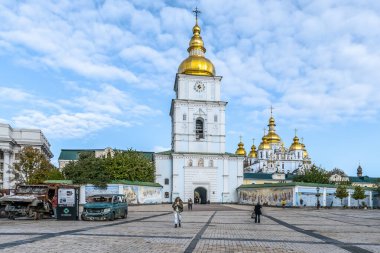 Saint Michael's Golden-Domed Monastery at Mykhailivska Square in Kyiv, with destroyed Russian military vehicles displayed in the foreground. Kyiv, Ukraine - October 27, 2023 clipart