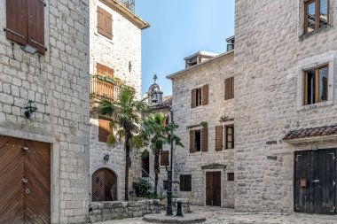 Karadağ 'ın Kotor kentinde sessiz bir avlu. Etrafı ahşap panjurlu ve ortasında küçük bir su pompası olan taş binalarla çevrili. Büyüleyici mimari bu Akdeniz şehrinin tarihini ve huzurunu yansıtıyor.
