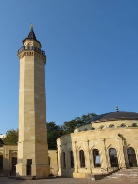 Kyiv, Ukraine - October 8, 2018: Tall beige minaret of the Ar-Rahma Mosque, vertical photo. Beautiful oriental style buildings - Islamic cultural center, outside clipart