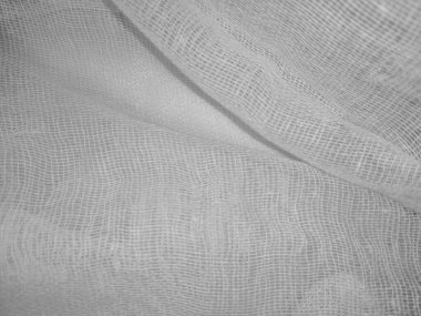Ağlı kumaş dokusuyla güzel beyaz bir zemin. Tekstil dokusu modeli için boş, pileli tıbbi gazlı bez.