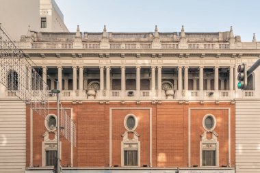 Iconic Gran Via 35 Building, known as Palacio de la Musica, was designed by Secundino Zuazo Ugalde in 1926, Spain. This historic structure features classical columns and an ornate facade, reflecting the architectural elegance of Madrid's Gran Via clipart