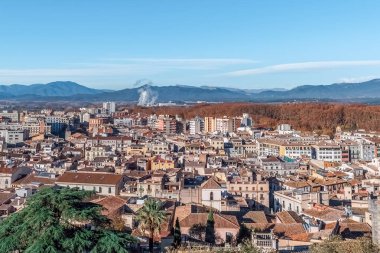 Tarihi binaları, terasotta çatıları ve arka planda mavi dağları olan Girona 'nın hava panoramik manzarası. Güneşli bir günde İspanya 'nın Katalonya kentindeki ortaçağ Akdeniz şehri