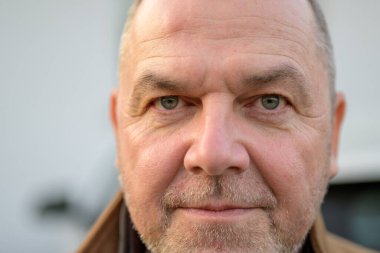 Close-up of a middle-aged man looking directly at the camera