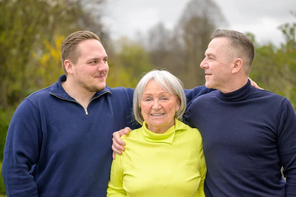 Three Generation Family Grandmother Son Grandson Hold Each Other Arms — Stock Photo, Image