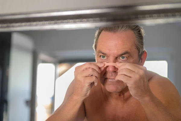Middle Aged Man Applying Nose Tape While Looking Mirror Bedroom — Stock Photo, Image