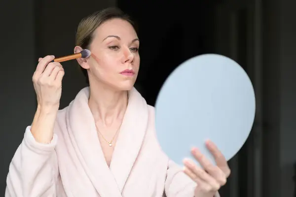 Blonde Woman Applying Makeup Brush Looking Mirror Home Royalty Free Stock Photos