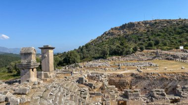 panoramic view captures the grandeur of the ancient city of Xanthos. The towering Lycian tombs stand as silent sentinels  clipart