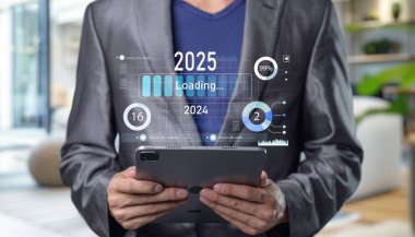 A businessman interacts with a tablet showing loading progress indicators for 2025, representing future trends and digital innovation in business analytics. Progress and transition from 2024 to 2025 clipart