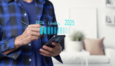 A person using a smartphone visualizing a timeline transition from 2024 to 2025. The loading graphic symbolizes progress and forward-thinking in a modern home environment. Progress and transition from 2024 to 2025 concept006 clipart